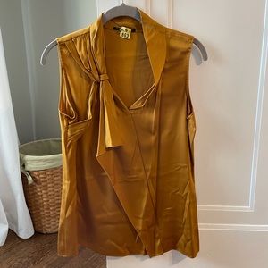 Silk top. Small. More of a dark mustard color than “gold”.